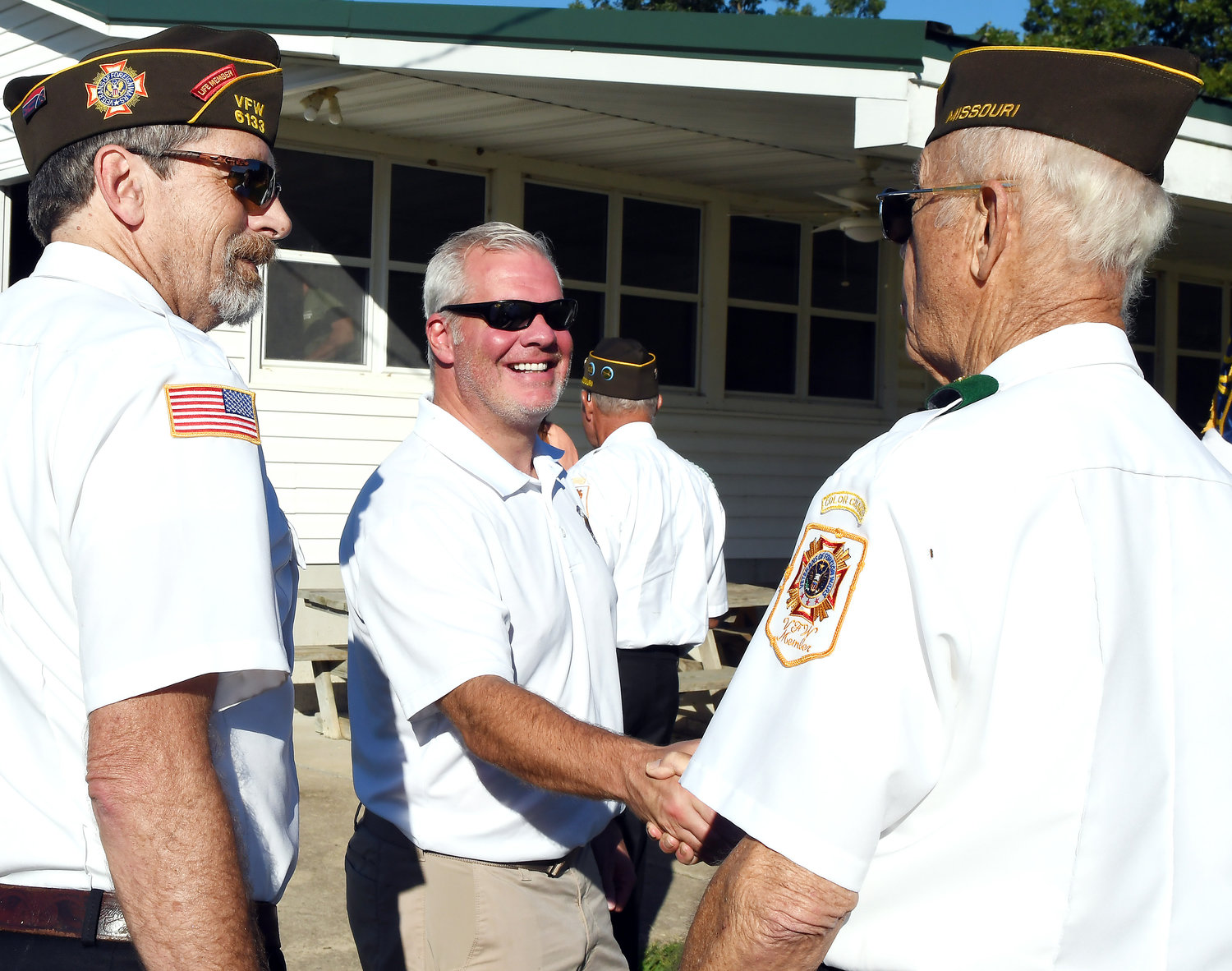 Bob Depperman, a member of VFW Post No. 6133 in Owensville, congratulates Bob Gassoff, Jr., following the Aug. 21 presentation ceremony. Looking on is John Colombo, director of the Missouri M1 for Vets Project. Depperman was a participant in the ceremony with the VFW color guard.